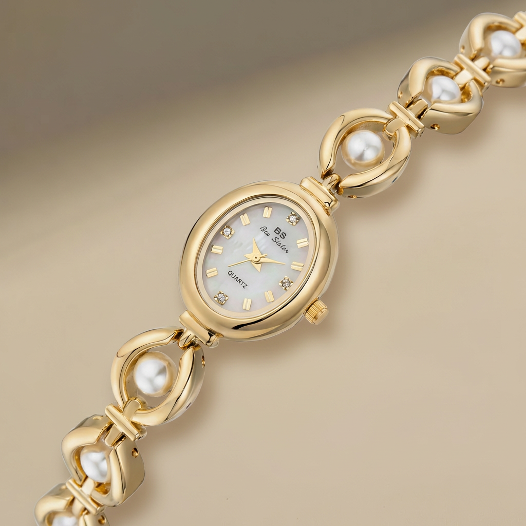 Gold wristwatch with pearl accents on a beige background