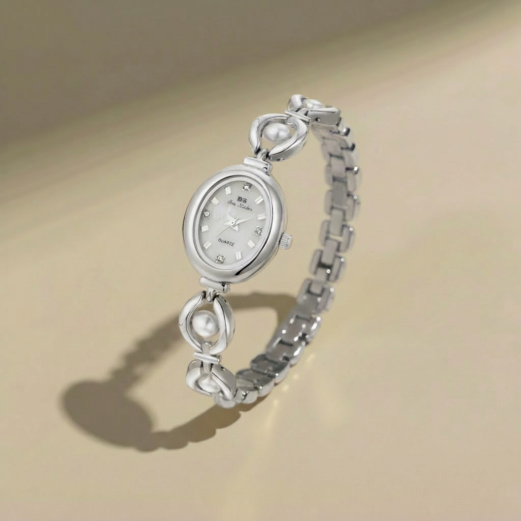 Silver watch with pearl-like embellishments on a beige background