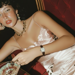 Woman in a vintage setting holding a cocktail glass